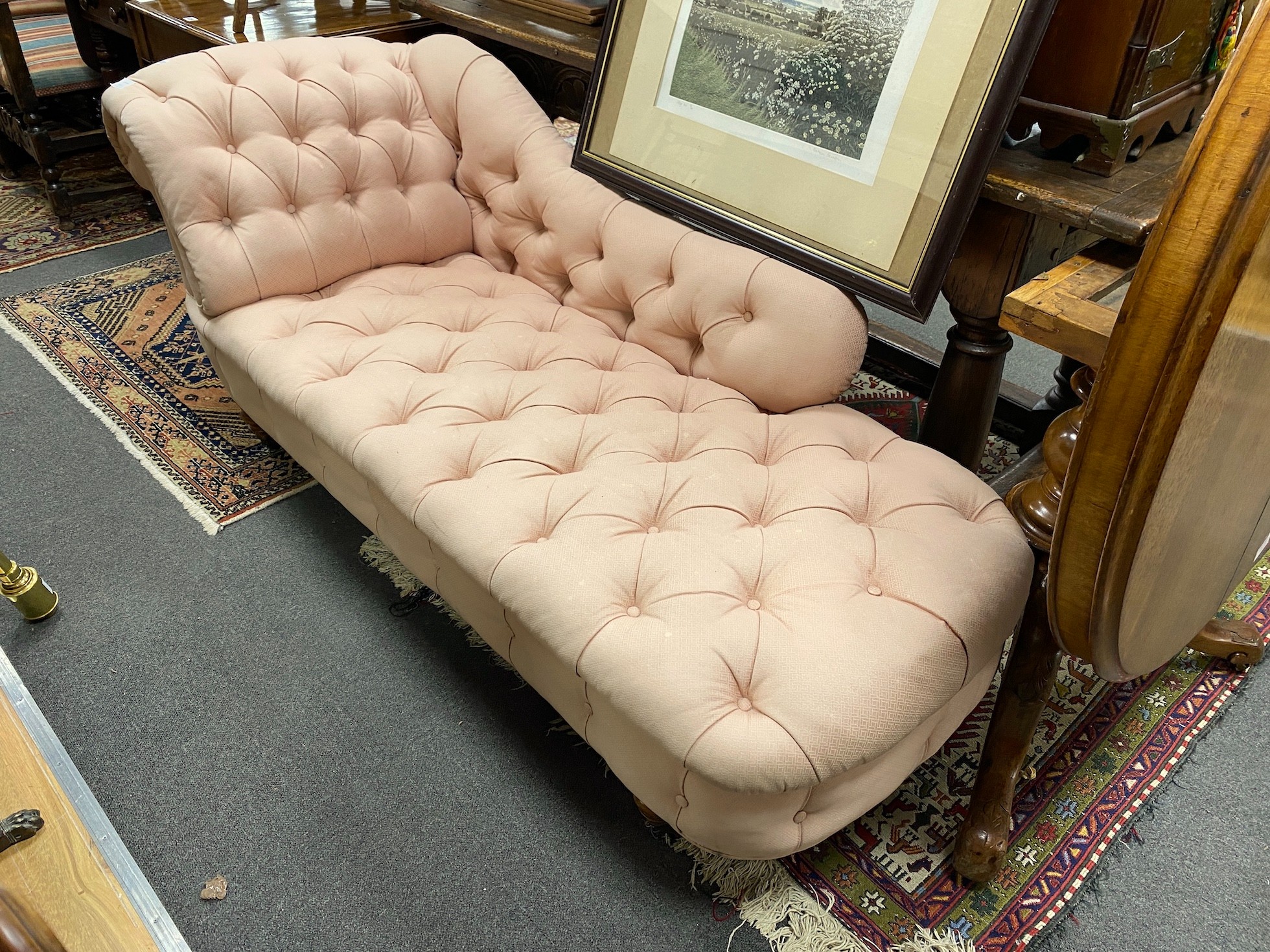 A small Victorian chaise longue with buttoned pink upholstery, length 180cm, depth 68cm, height 68cm